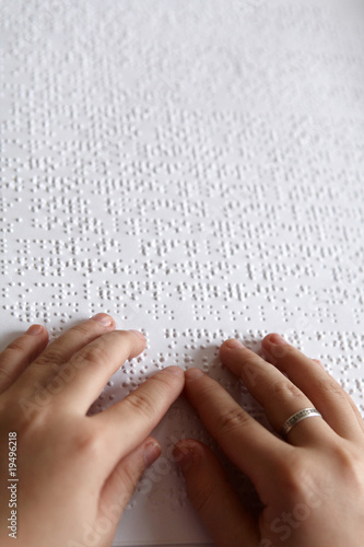 hands of children and Braille print