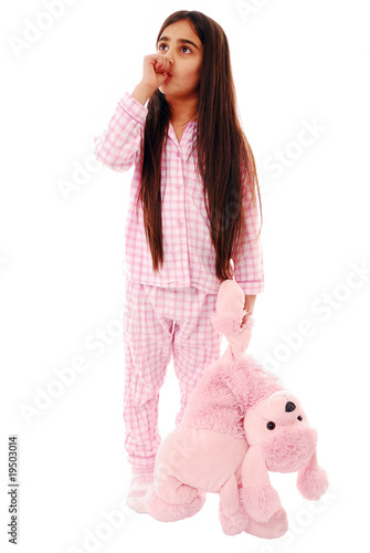 Fotografi Girl sucking her thumb ready for bed isolated on white