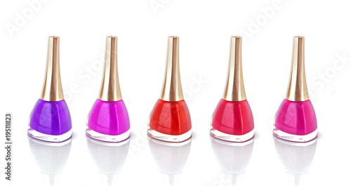 Group of nail polishes of different colors on white background