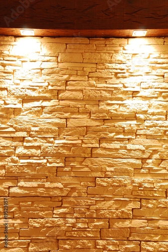 Unshaped stone wall with spot lights photo