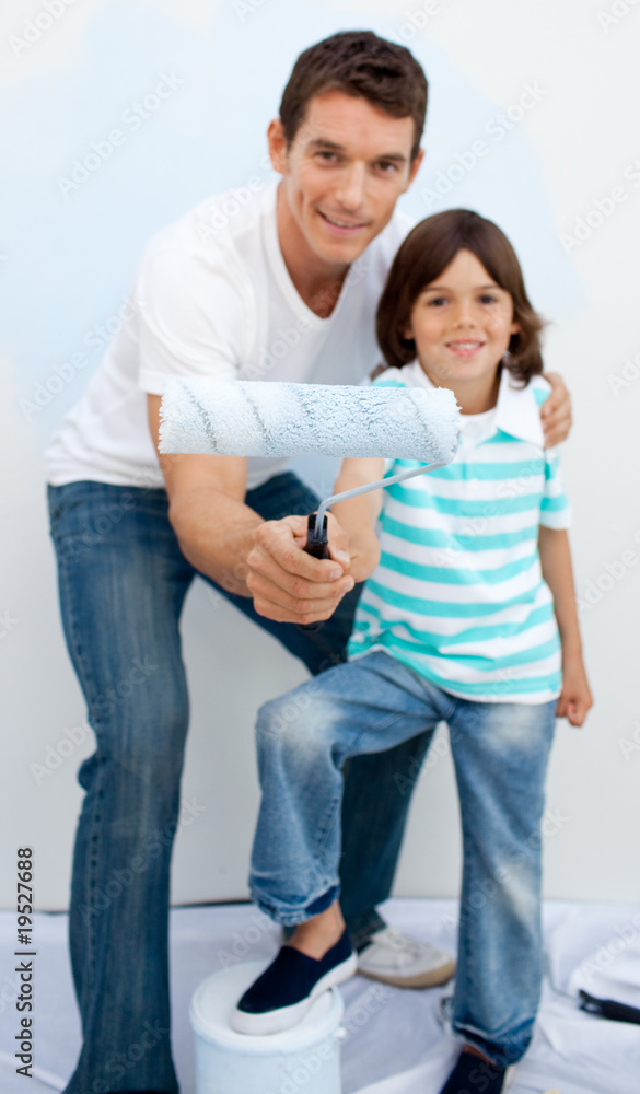 Father and his son paiting a room Father and his son paiting a room