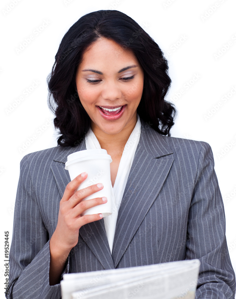 Young businesswoman drinking a coffee while reading a newspaper Young businesswoman drinking a coffee while reading a newspaper