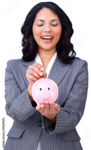 Positive businesswoman saving money in a piggybank