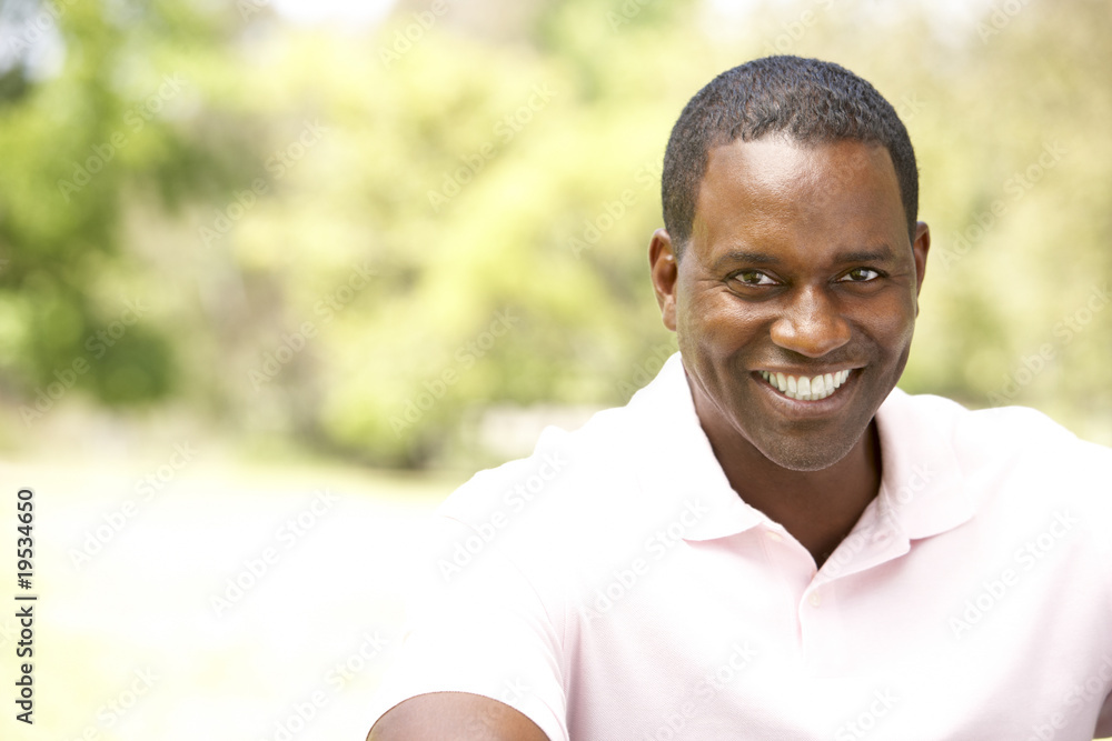 Portrait Of Young Man Sitting In Park Portrait Of Young Man Sitting In Park