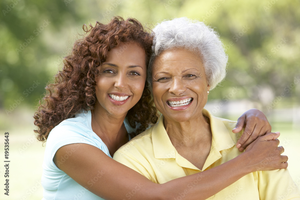 Senior Woman With Adult Daughter In Park Senior Woman With Adult Daughter In Park