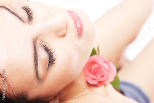 Beautiful woman with flower isolated on white