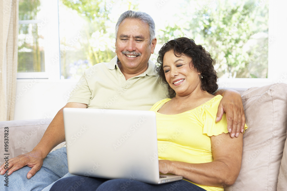Senior Couple Using Laptop At Home Senior Couple Using Laptop At Home