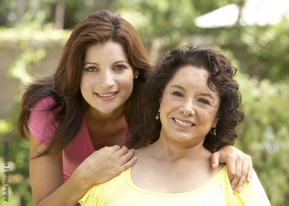 Senior Woman With Adult Daughter In Garden