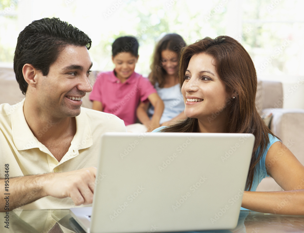 Parents Using Laptop At Home Parents Using Laptop At Home