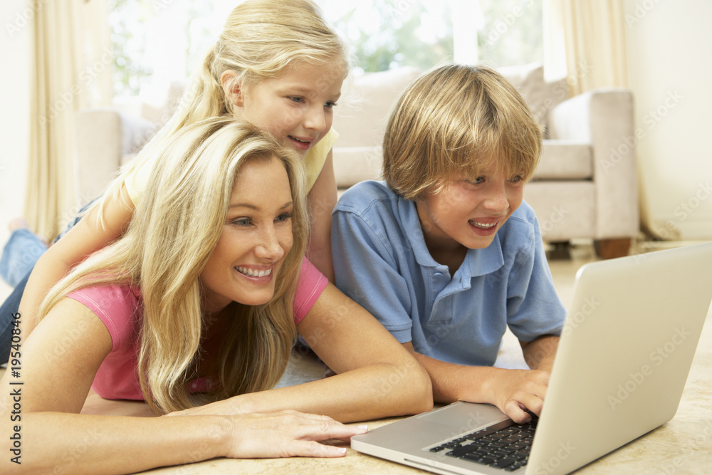 Mother And Children Using Laptop At Home Mother And Children Using Laptop At Home