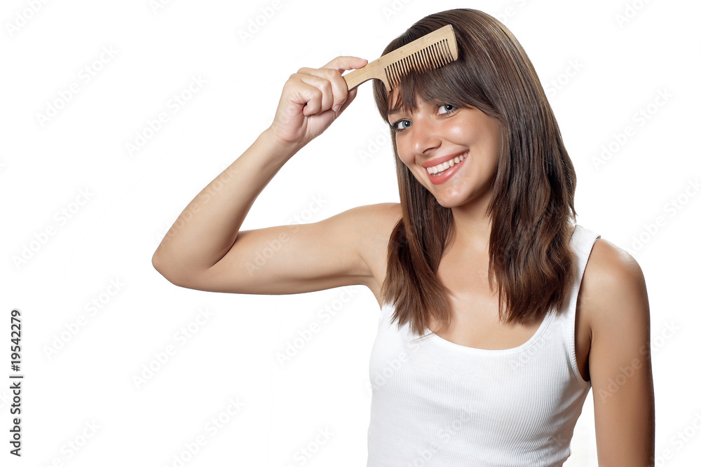 Beautiful brunette woman with wooden hairbrush Beautiful brunette woman with wooden hairbrush