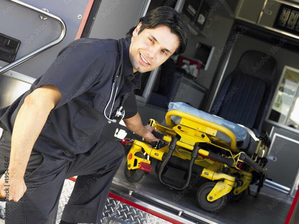 Paramedic removing empty gurney from ambulance Stock Photo Adobe Stock