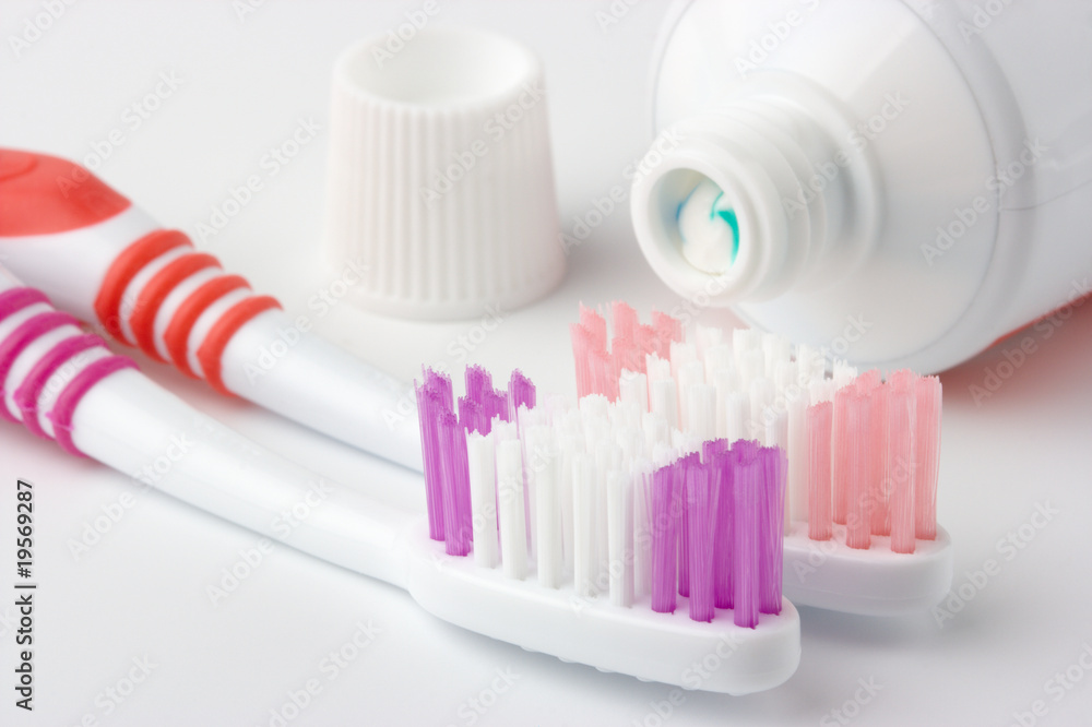 Two toothbrushes and toothpaste - common toiletries Two toothbrushes and toothpaste - common toiletries