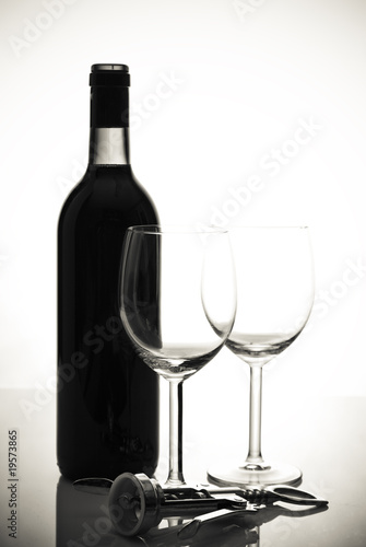 bottle of wine and wineglasses on white background
