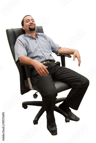Fotografie Slacking off - An Indian executive relaxes in an office chair