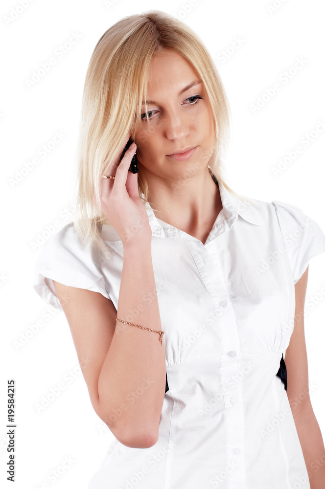 Fototapeta premium charming blonde businesswoman in a white shirt with phone