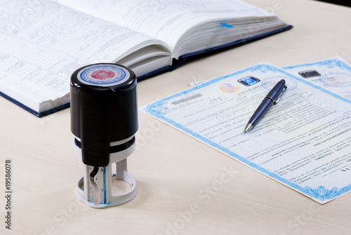 Canvastavla stamp and notary's book on the table and the document signed by