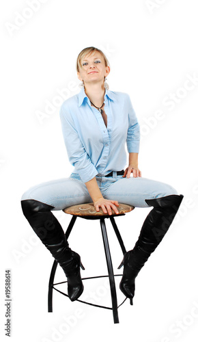 Lady in blue jeans sitting on chear photo