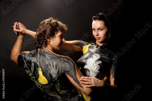 dancing young caucasian couple standing isolated on black