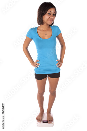 woman in blue on scales smiling