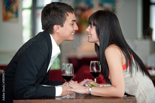 Couple Kiss Over Meal