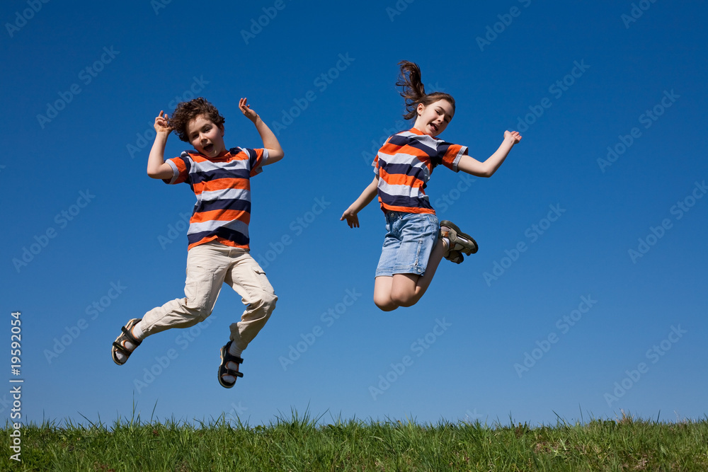 Kids jumping, running against blue sky Kids jumping, running against blue sky