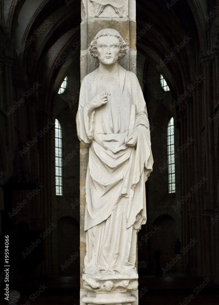 Man of a God. Entrance of the XIII century church. France.