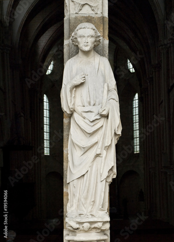 Man of a God. Entrance of the XIII century church. France.