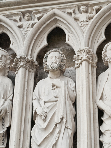 Holy man. Entrance of the XIII century church. France.