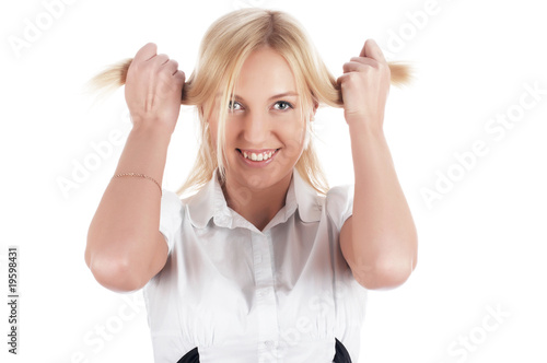 The cheerful charming blonde in a white shirt