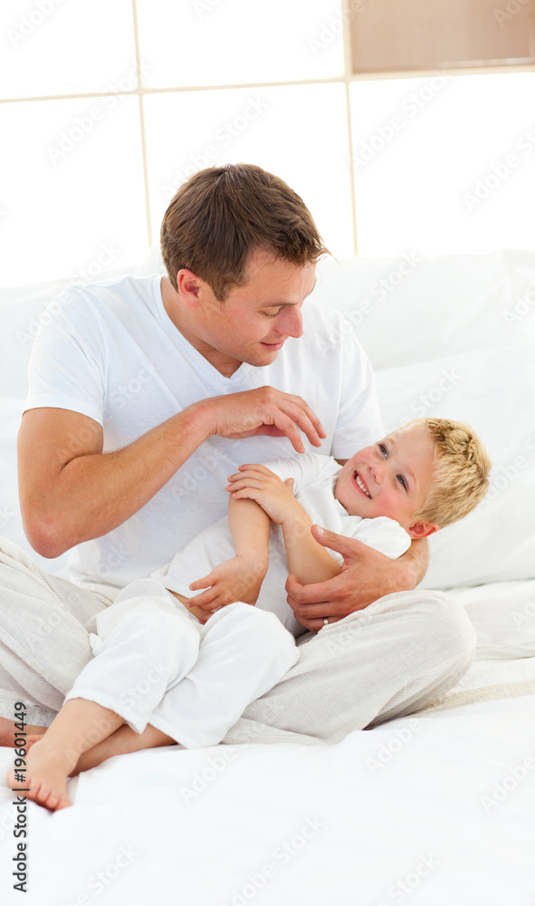 Animated dad and his little boy playing on a bed Animated dad and his little boy playing on a bed