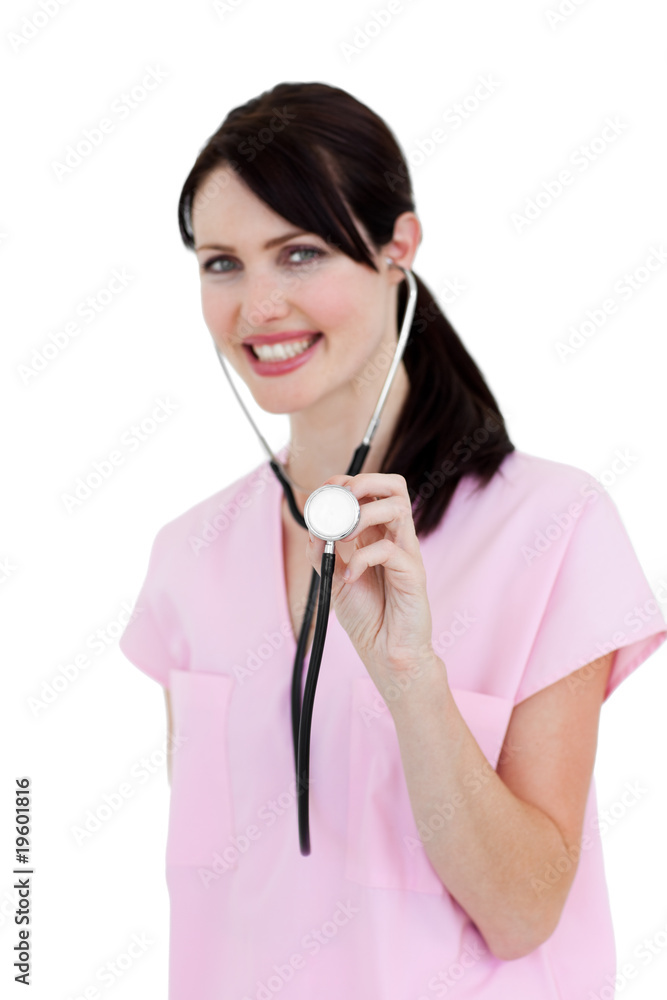 Radiant nurse showing a stethoscope against a white background Radiant nurse showing a stethoscope against a white background