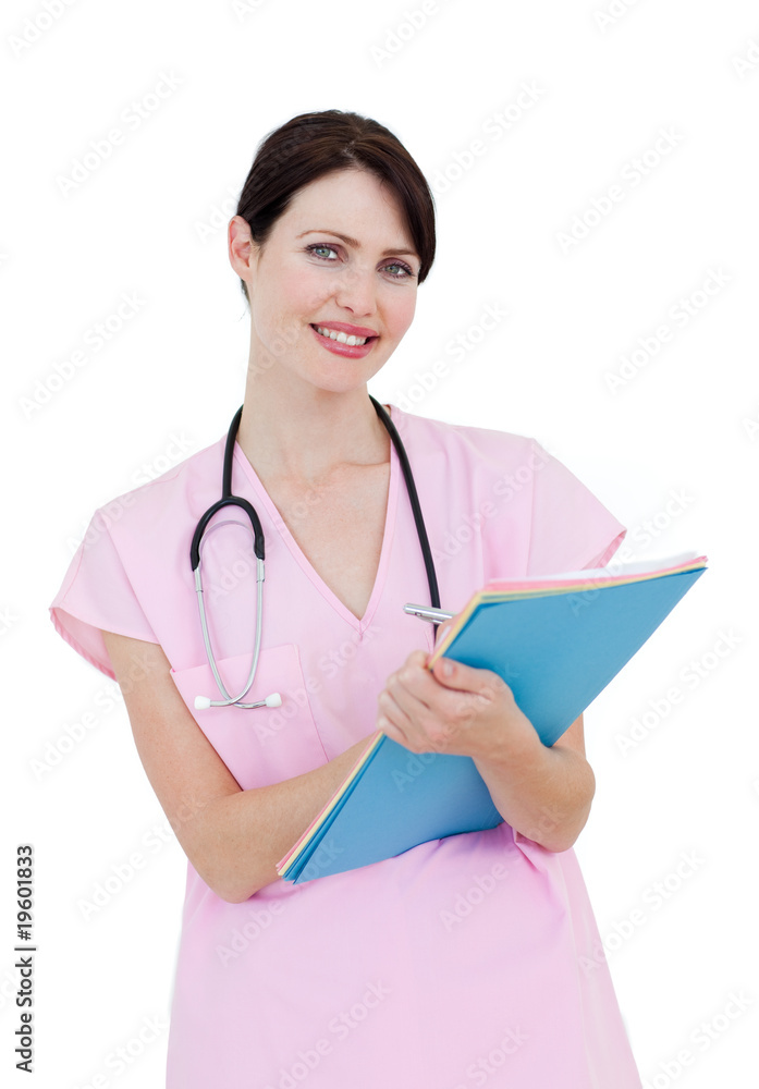 Charming female nurse writing on a clipboard Charming female nurse writing on a clipboard