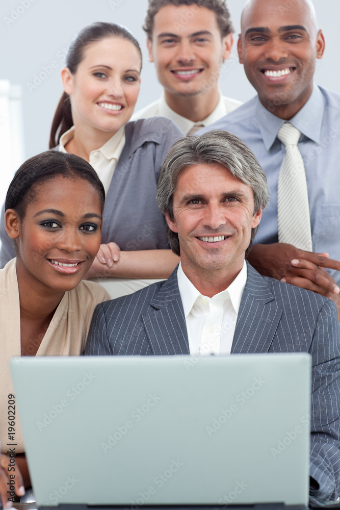 A diverse business team working at a laptop A diverse business team working at a laptop