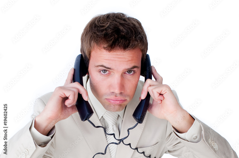 Annoyed businessman tangle up in phone wires Annoyed businessman tangle up in phone wires