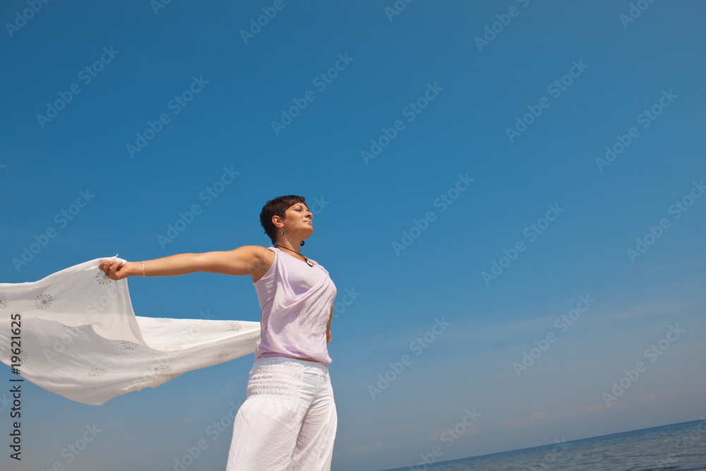 happy woman with a scarf on the beach