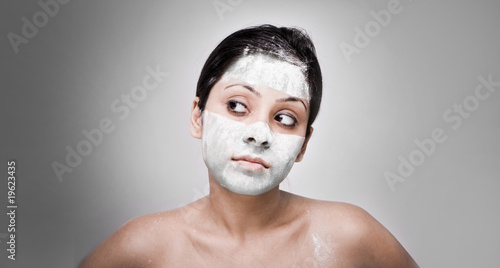 Cosmetician make mask to girl. Facial massage. © stryjek