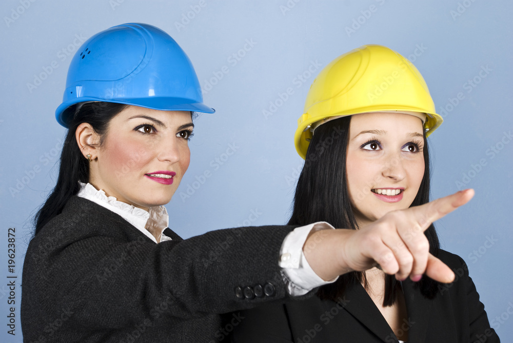 Two architects women pointing Two architects women pointing