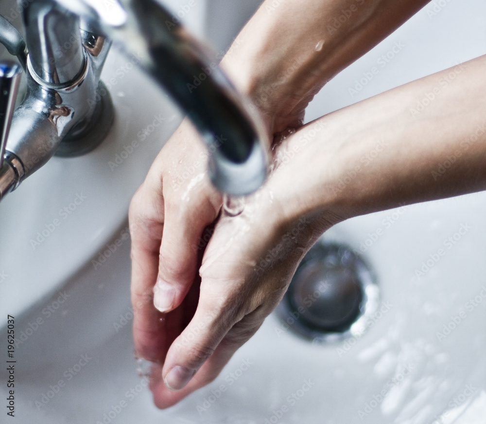 Washing hands under tap