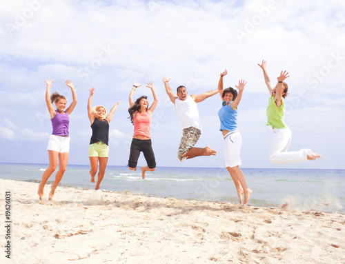 happy jumping people on the beach