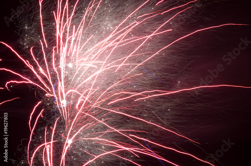 long exposure of multiple fireworks against a black sky
