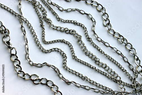 Various silver chains on a white background