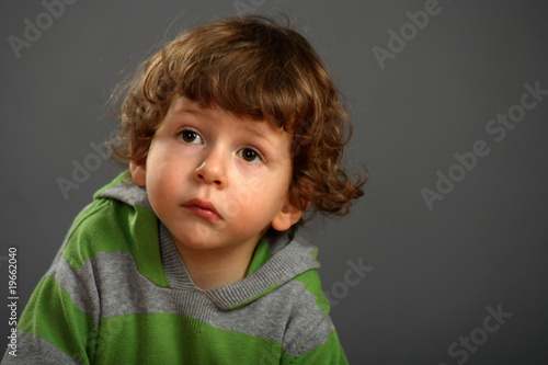 Portrait of a nice little boy with a beautiful curly hair