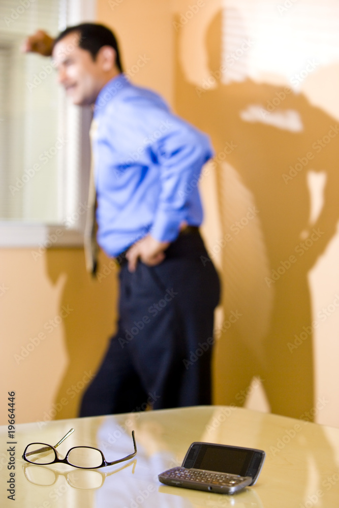 Eyeglasses and phone on table, businessman thinking Eyeglasses and phone on table, businessman thinking