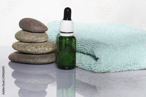pyramid of pebbles,  towel and aroma oil