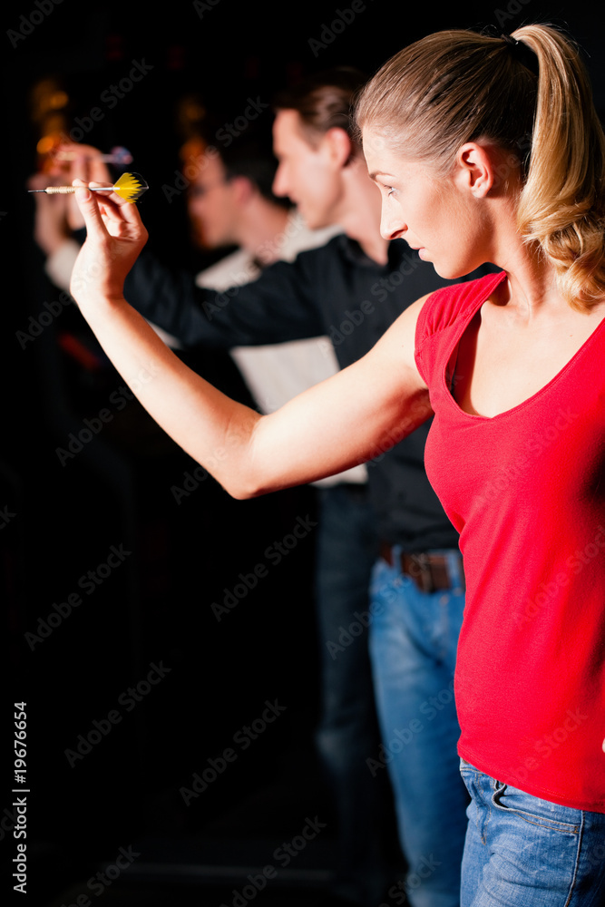 Group of friends playing darts Group of friends playing darts