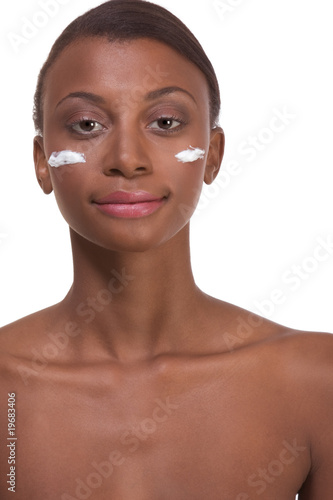 Topless ethnic Black woman moisturizing face