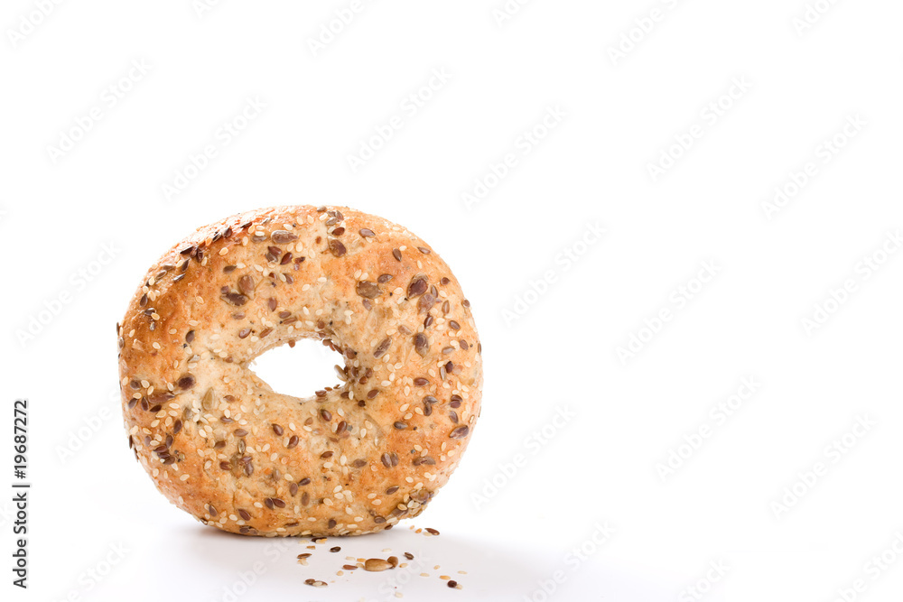 Wholegrain bagel stood on edge on white background Wholegrain bagel stood on edge on white background