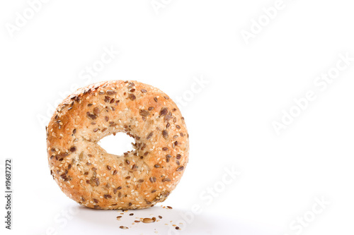 Wholegrain bagel stood on edge on white background