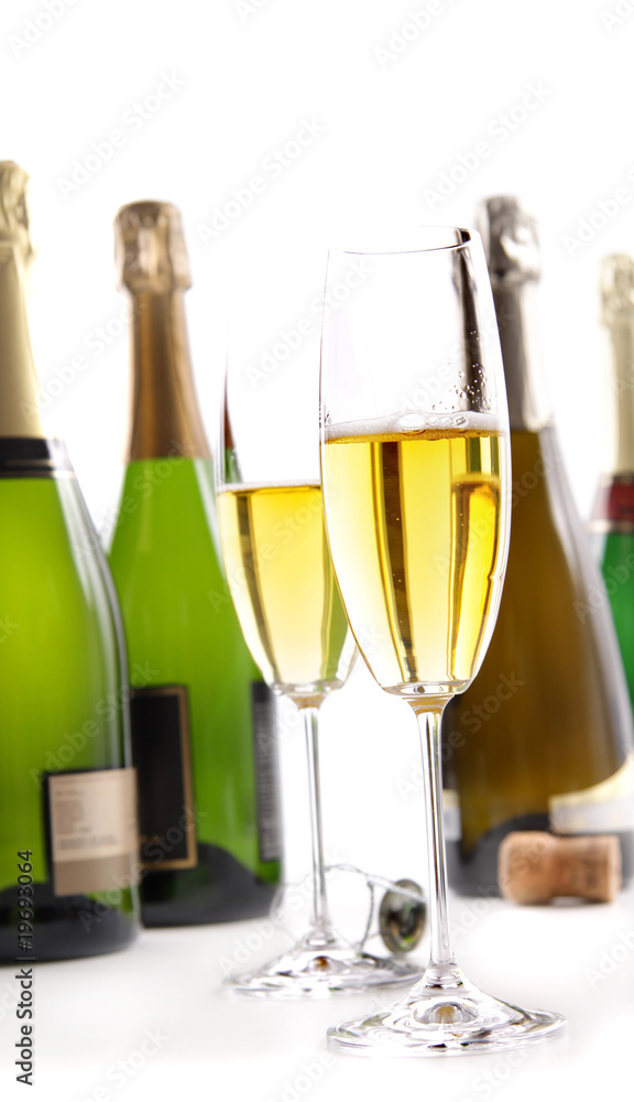Glasses of champagne with bottles on white Glasses of champagne with bottles on white